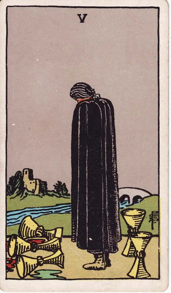 Five of Cups tarot card from the Rider-Waite-Smith deck: a cloaked figure grieving over three spilled cups, two still standing behind him.