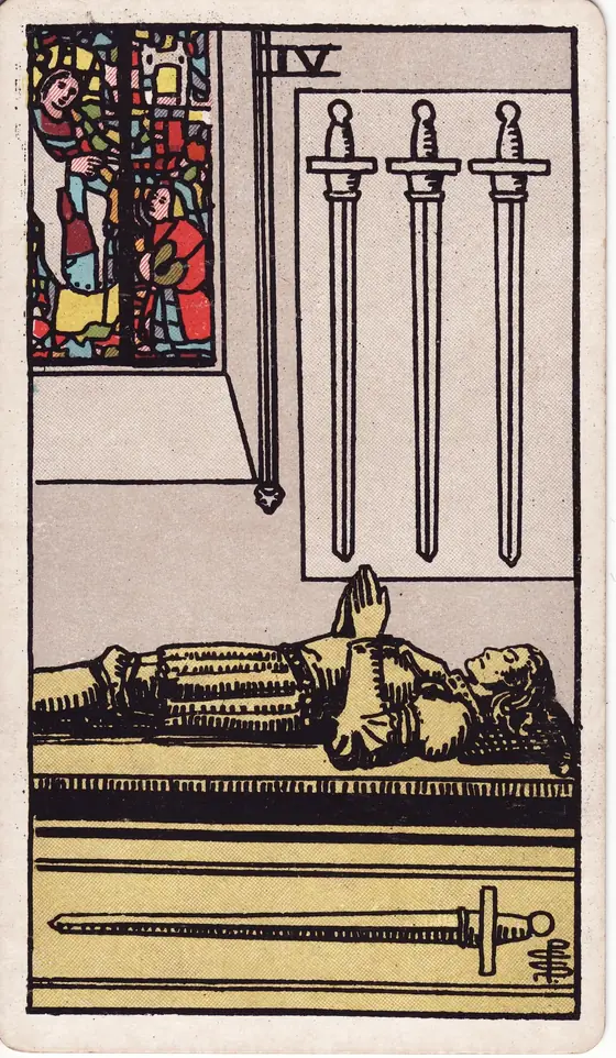 Four of Swords tarot card from the Rider-Waite-Smith deck: a knight lying in effigy on a tomb, one sword beneath him and three hung on the wall.