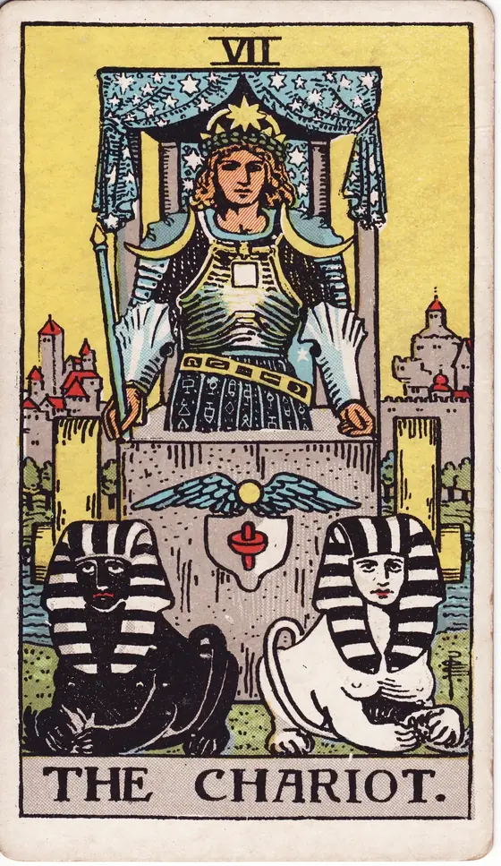 The Chariot tarot card from the Rider-Waite-Smith deck: an armoured driver in a canopied chariot drawn by one black and one white sphinx.