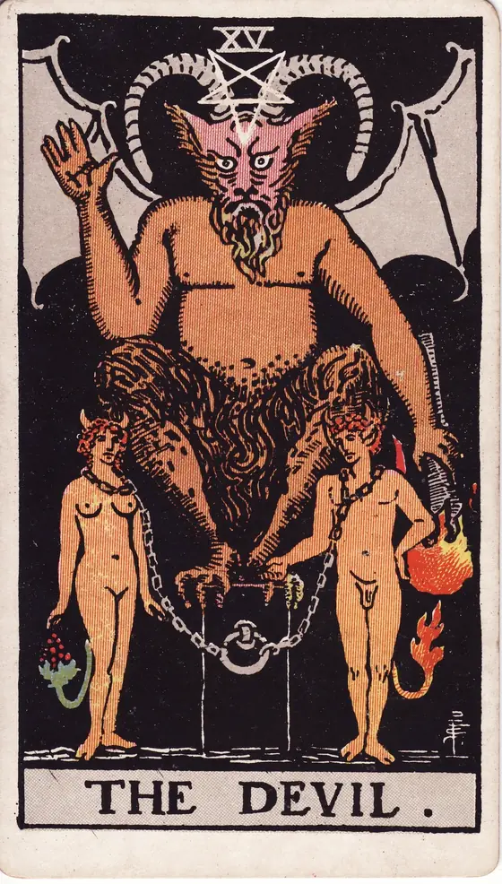 The Devil tarot card from the Rider-Waite-Smith deck: a horned figure crouched on a plinth above a man and a woman held by loose chains.