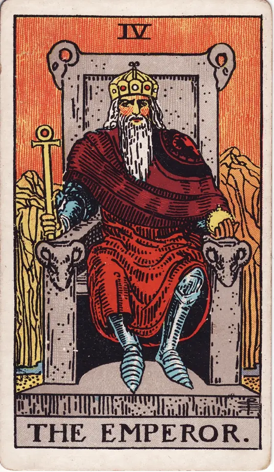 The Emperor tarot card from the Rider-Waite-Smith deck: a bearded ruler on a stone throne carved with rams' heads, an ankh sceptre in his hand.