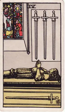 Four of Swords tarot card from the Rider-Waite-Smith deck: a knight lying in effigy on a tomb, one sword beneath him and three hung on the wall.
