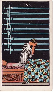 Nine of Swords tarot card from the Rider-Waite-Smith deck: a figure sitting up in bed with face in hands, nine swords on the wall behind.