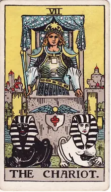 The Chariot tarot card from the Rider-Waite-Smith deck: an armoured driver in a canopied chariot drawn by one black and one white sphinx.