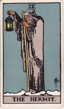 The Hermit tarot card from the Rider-Waite-Smith deck: a grey-robed figure alone on a peak, raising a lantern lit by a six-pointed star.