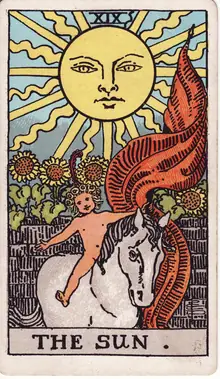 The Sun tarot card from the Rider-Waite-Smith deck: a child on a white horse beneath a beaming sun, sunflowers rising over a garden wall.