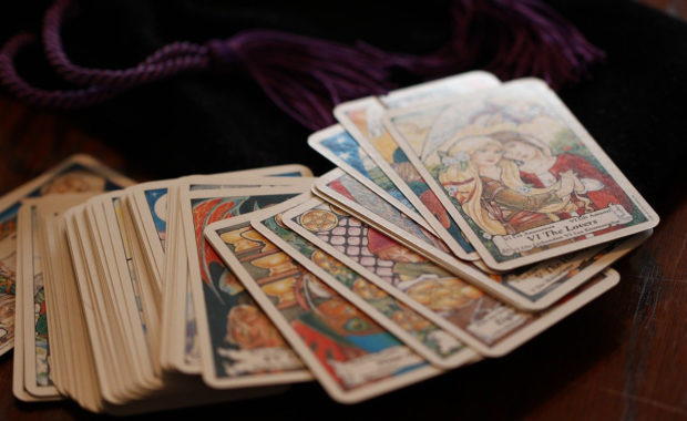 colorful tarot cards spread out on table