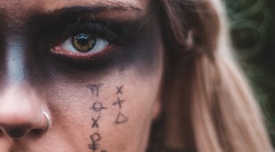 Woman with astrology symbols painted on face